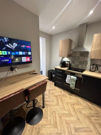 Modern Kitchen With Wooden Countertops, A Tiled Ba...