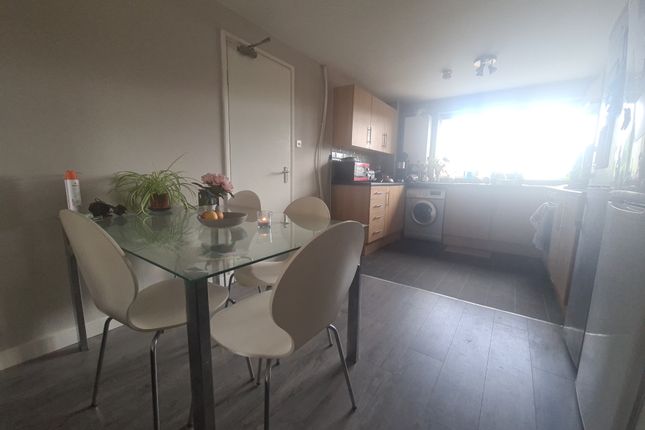 A Bright And Tidy Kitchen Featuring A Glass Dining...