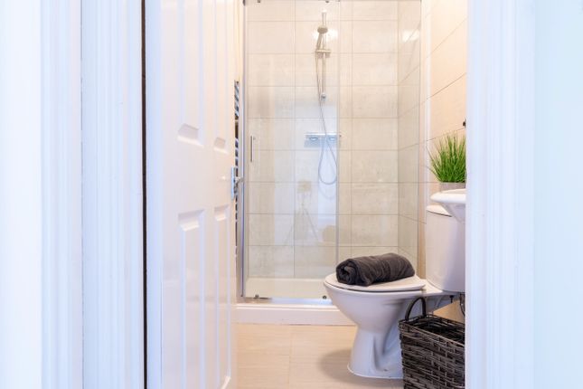 A Modern Bathroom Featuring A Spacious Shower, Sle...