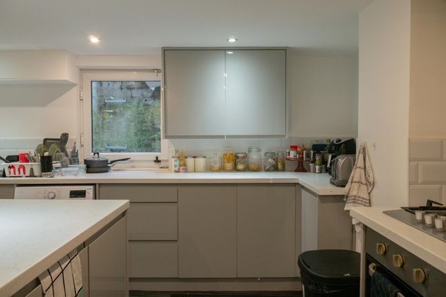 A Modern, Well-Lit Kitchen Featuring Ample Counter...