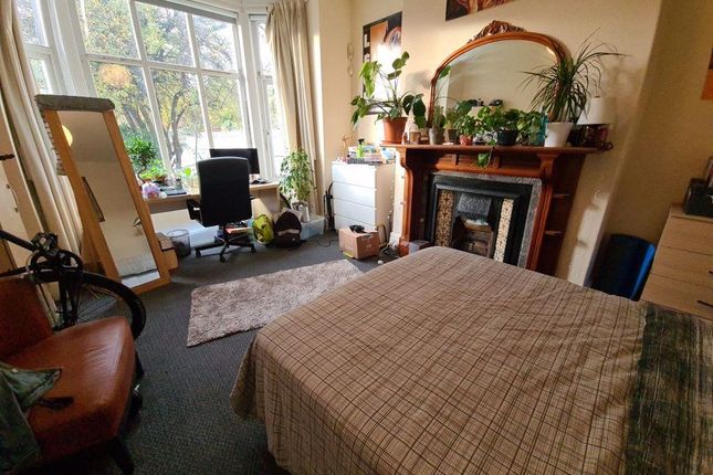 A Bright And Welcoming Living Room With Large Wind...