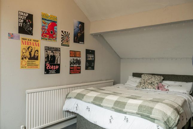 A Cozy, Well-Organized Bedroom Featuring A Double ...