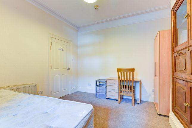 Bright And Tidy Single Bedroom Featuring A Wooden ...