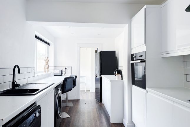 Bright, Modern Galley Kitchen With White Cabinetry...