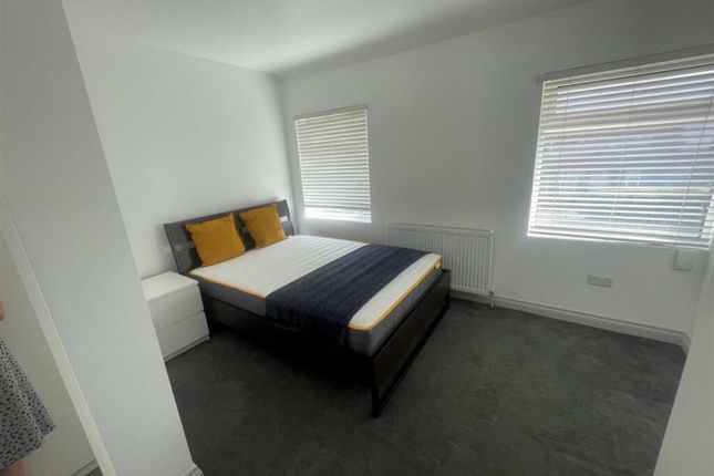 A Tidy And Well-Lit Double Bedroom Featuring A Bed...