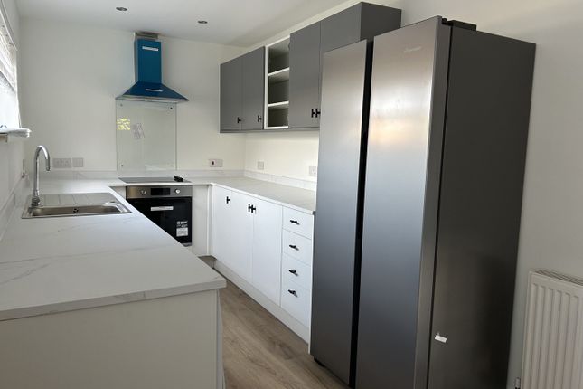 A Modern And Spacious Kitchen Featuring Ample Stor...
