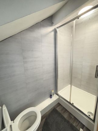 A Modern And Clean Bathroom Featuring A Toilet And...