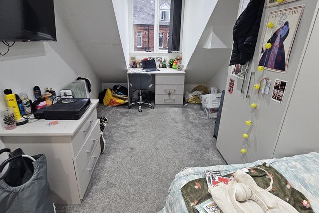 A Cozy Living Room Featuring A Window That Allows ...