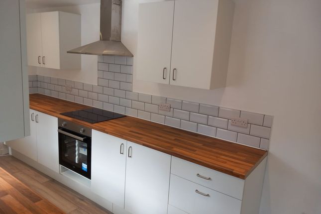 A Modern Kitchen Featuring Clean White Cabinetry, ...