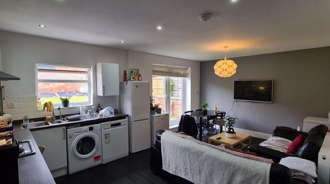 A Spacious And Well-Lit Living Room Featuring Mode...