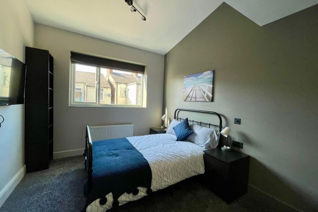 This Inviting Double Bedroom Features A Comfortabl...