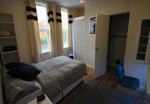 A Cozy Bedroom Featuring A Single Bed Near A Windo...