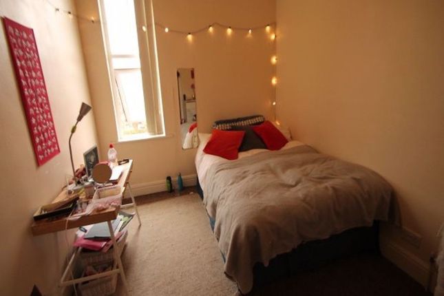 A Cozy Single Bedroom Featuring A Comfortable Bed ...