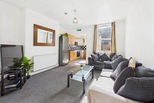 A Bright And Spacious Living Room With A Large Sof...