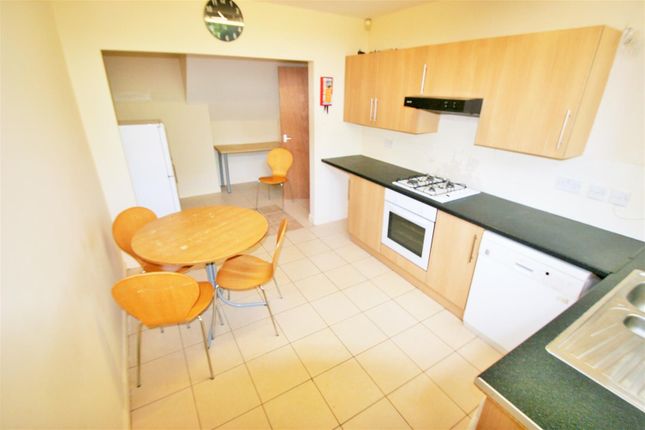 Bright And Functional Kitchen Featuring Wooden Cab...
