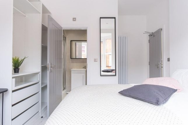 A Bright And Tidy Bedroom Featuring A Neatly Made ...