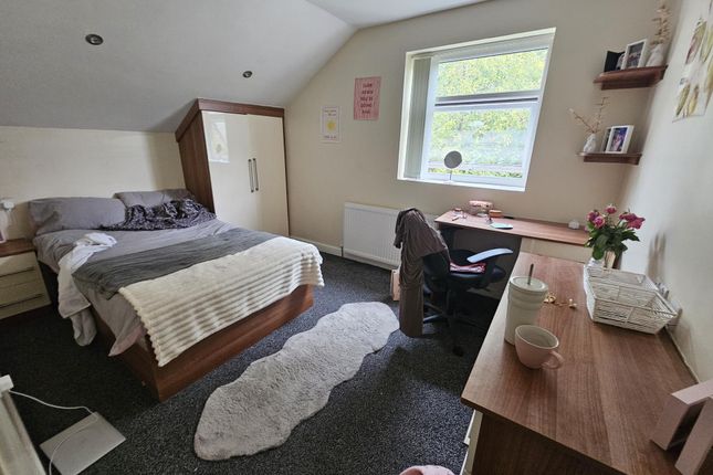 Spacious And Well-Lit Bedroom Featuring A Comforta...