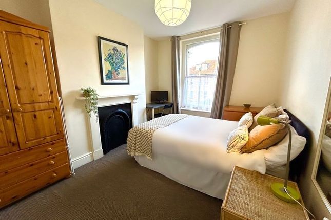A Charming Double Bedroom Featuring A Cozy Bed, St...