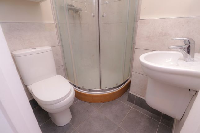 A Modern And Clean Bathroom Featuring A Sleek Show...