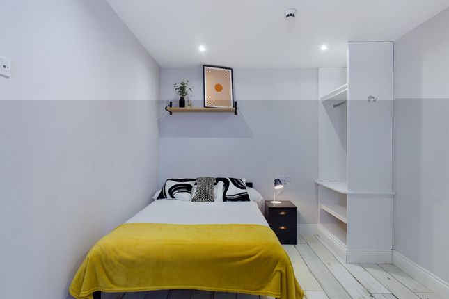 A Neat And Modern Single Bedroom Featuring A Cozy ...