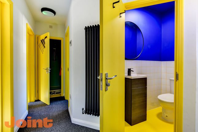 A Bright And Modern Hallway Featuring Vibrant Yell...