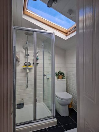 A Modern Bathroom Featuring A Glass-Enclosed Showe...