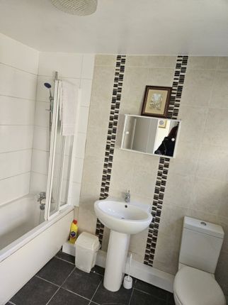 A Well-Maintained Bathroom Featuring A Bathtub And...