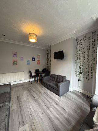 Bright And Inviting Living Room Featuring A Comfor...