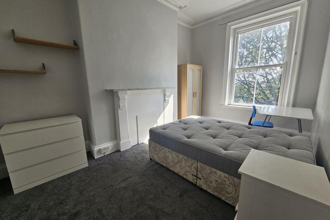 A Cozy Bedroom Featuring A Comfortable Double Bed ...