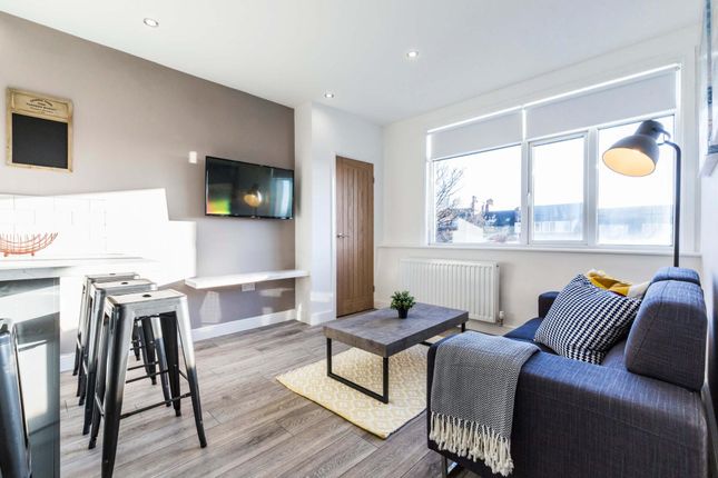 A Bright And Welcoming Living Room With Modern Fur...