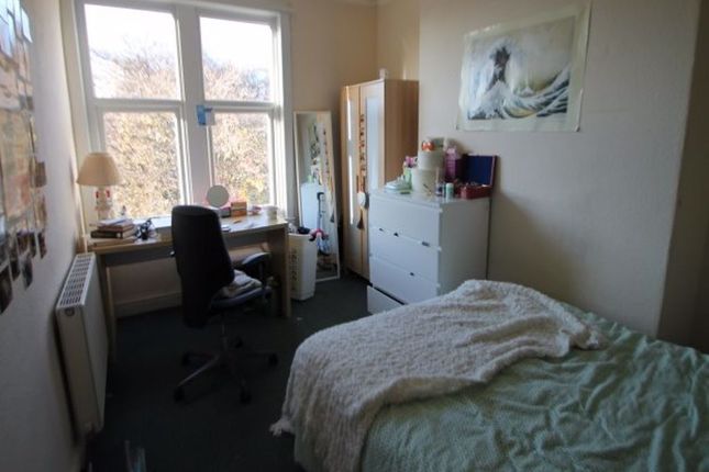 A Cozy Student Bedroom Featuring A Single Bed, A S...