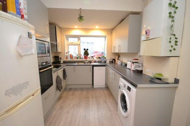 A Tidy And Well-Lit Kitchen Featuring Modern Appli...