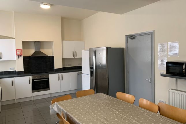 A Modern Communal Kitchen Featuring Ample Seating ...