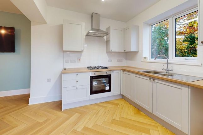 A Bright And Modern Kitchen Featuring Stylish Cabi...