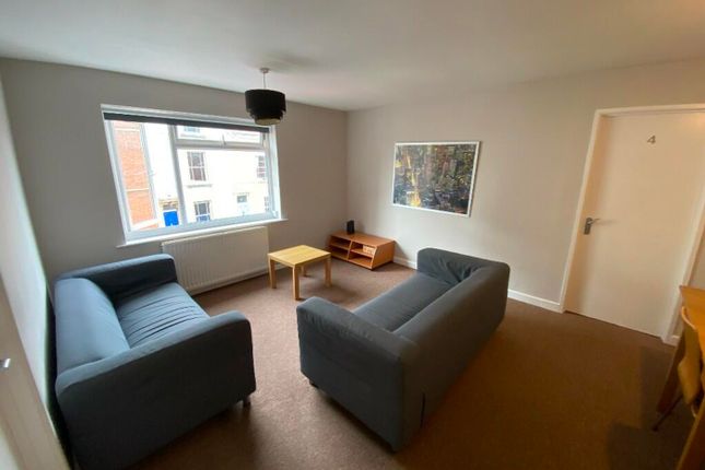 Bright And Inviting Living Room Featuring Comforta...