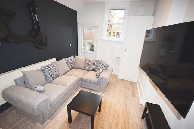 This Stylish Living Room Features A Comfortable Co...