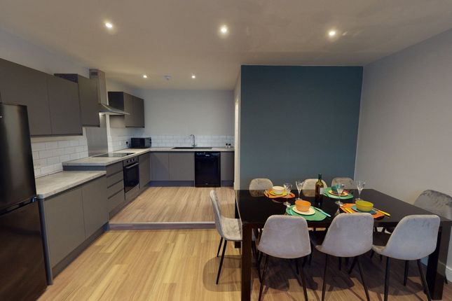 A Modern And Spacious Kitchen Area Featuring Sleek...