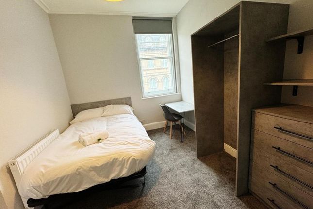 A Bright And Inviting Double Bedroom With Modern F...