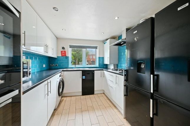 Bright And Modern Kitchen Featuring Sleek White Ca...