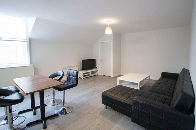 A Bright And Spacious Living Room Featuring Modern...