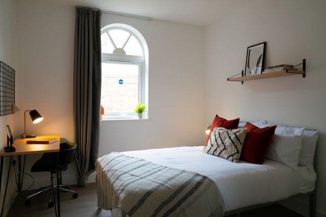 A Bright And Inviting Double Bedroom With A Cozy A...