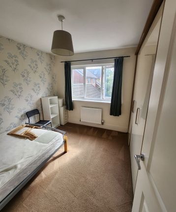 A Neat And Bright Single Bedroom Featuring A Large...