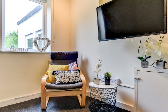 A Cozy And Well-Maintained Living Room Featuring A...