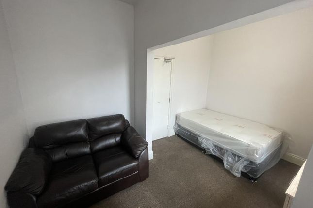 Compact Bedroom With A Comfortable Dark Leather So...