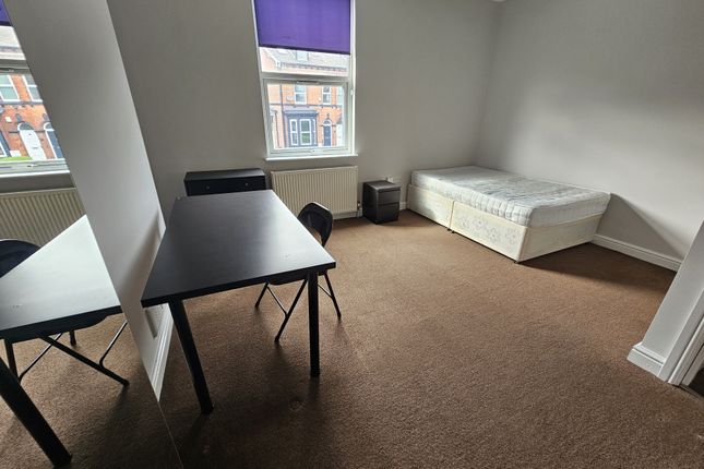 A Bright And Tidy Bedroom Featuring A Single Bed, ...