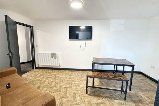 A Bright, Spacious Living Room With A Large Window...