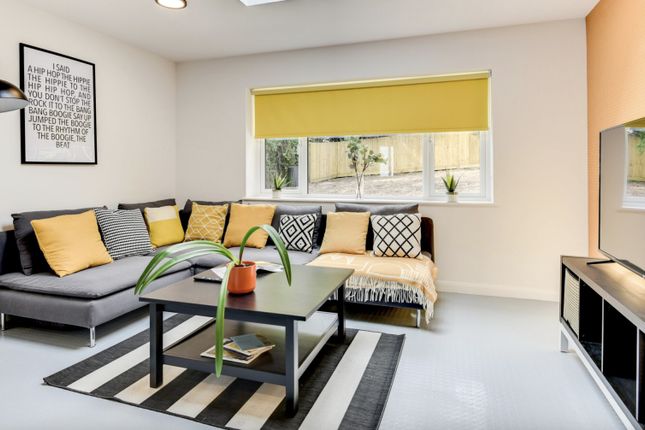 A Modern And Inviting Living Room Featuring A Cozy...