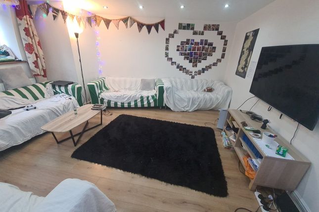 A Cozy And Inviting Living Room Featuring Multiple...