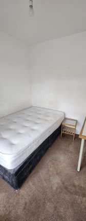 A Simple, Tidy Single Bedroom Featuring A Comforta...