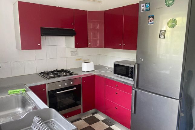 A Modern Kitchenette Featuring Vibrant Red Cabinet...